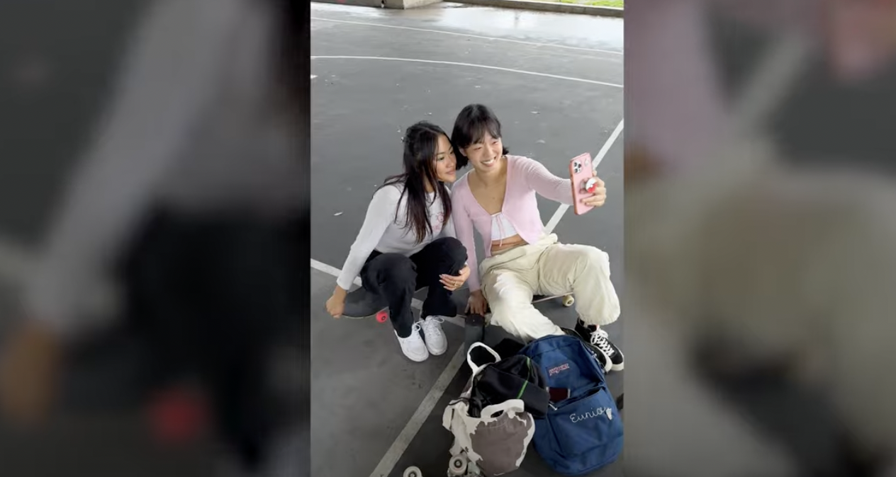 Two teenagers take a selfie with JanSport backpacks and roller skates in frame.