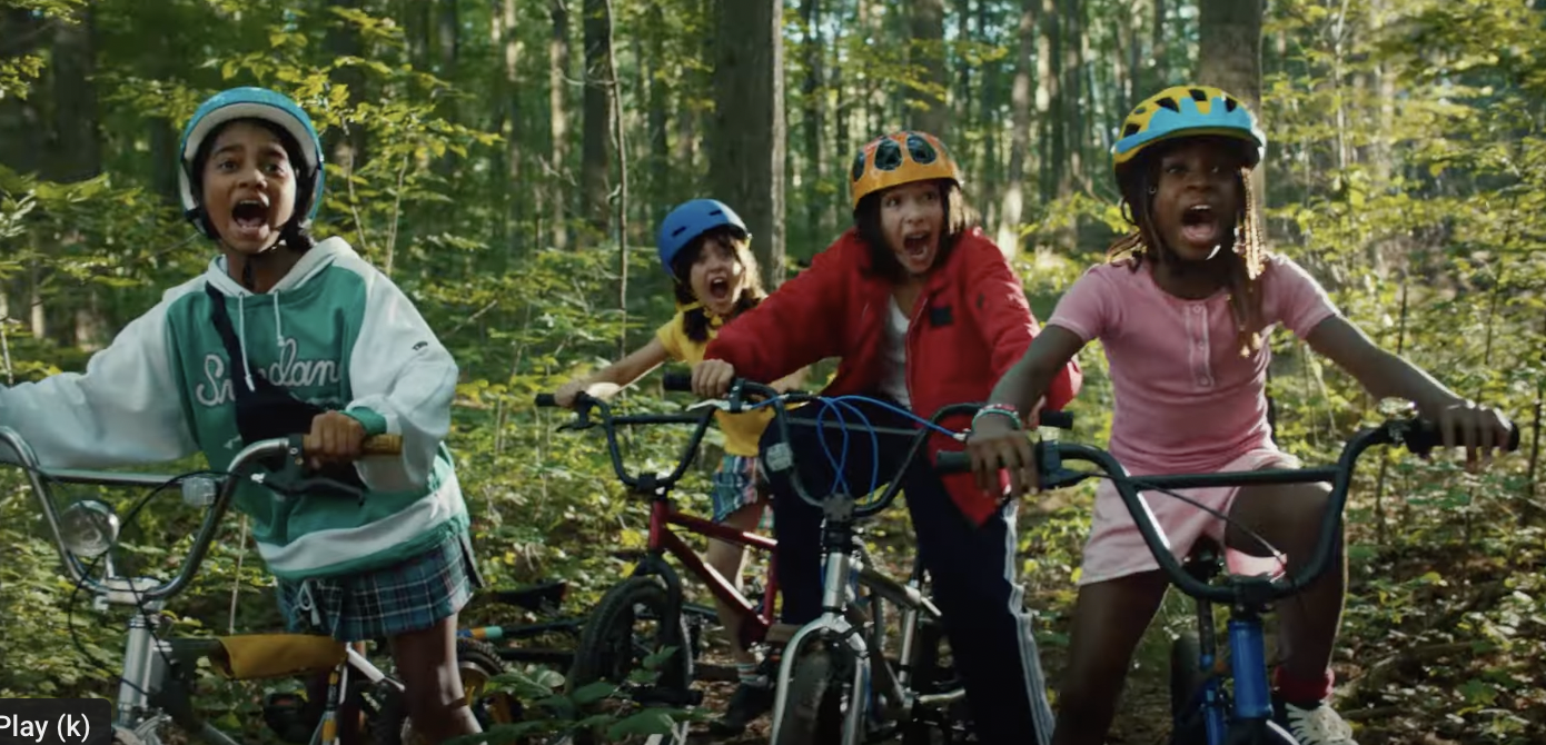A group of children on bikes in the forest scream in shock