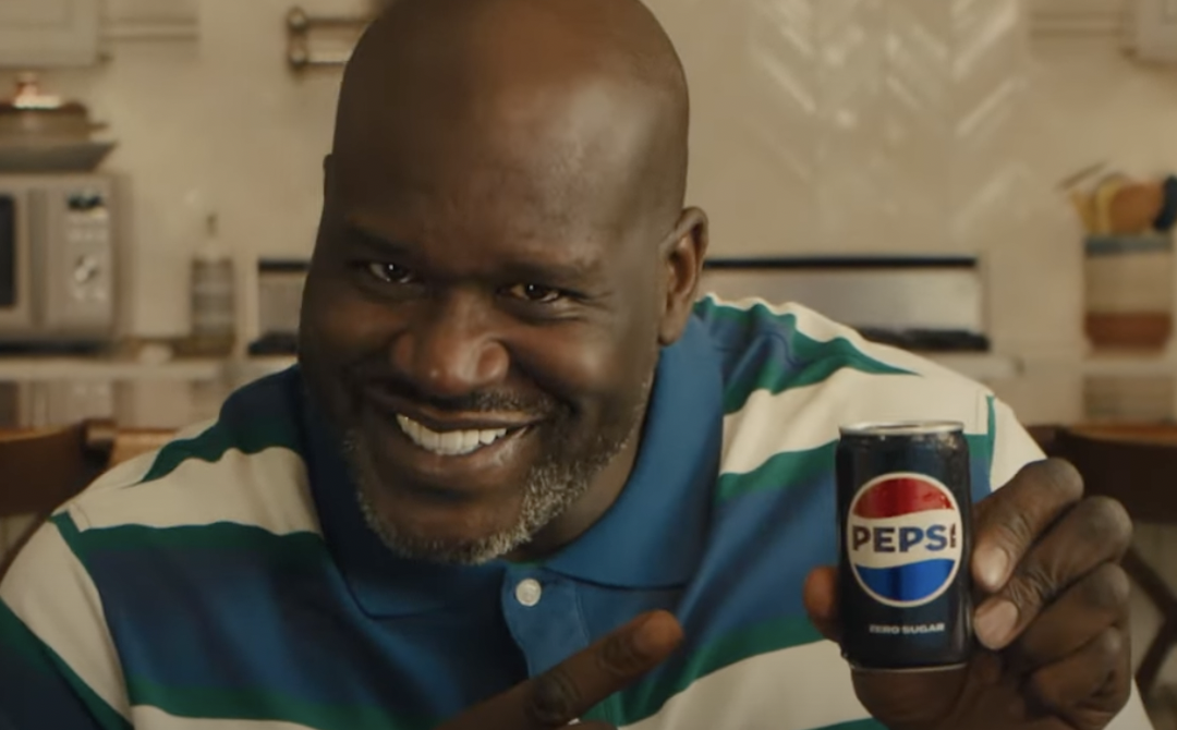 Shaq holds a mini can of Pepsi