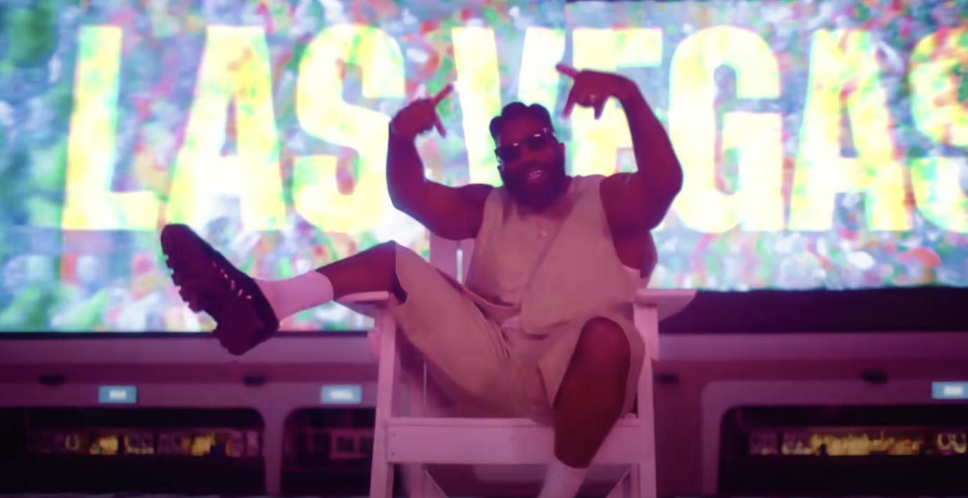 Tobe Nwigwe raps in front of a giant LAS VEGAS sign