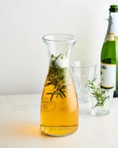 A decanter of alcohol infused with rosemary