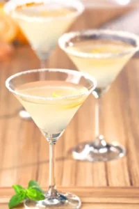 A peach cocktail in three martini glasses