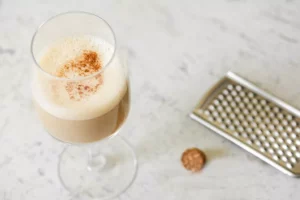 A rum eggnog cocktail with grated nutmeg