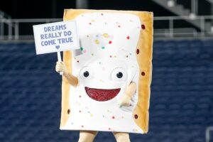 A poptart mascot holds a sign that says "Dreams Do come True"
