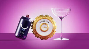 A can of Bubly, a cocktail glass, and a luxe "Press for Bubly" doorbell button